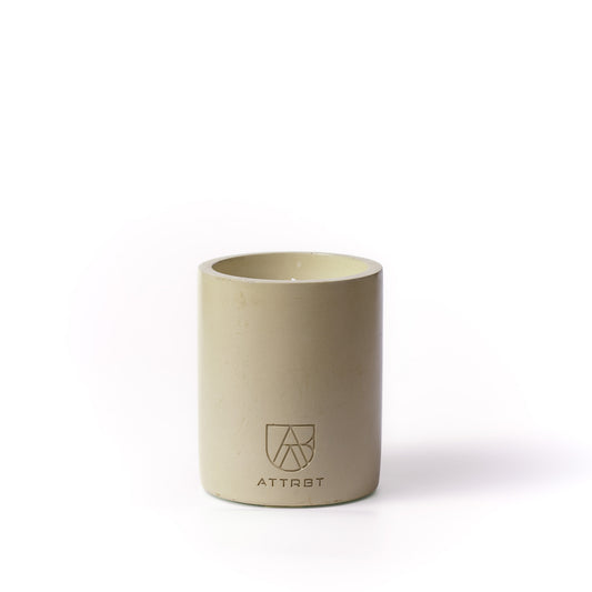 A minimalist one-wick candle in a light beige color cylindrical concrete container, featuring the 'ATTRBT' brand logo on the front, set against a clean white background.
botanic concrete candle