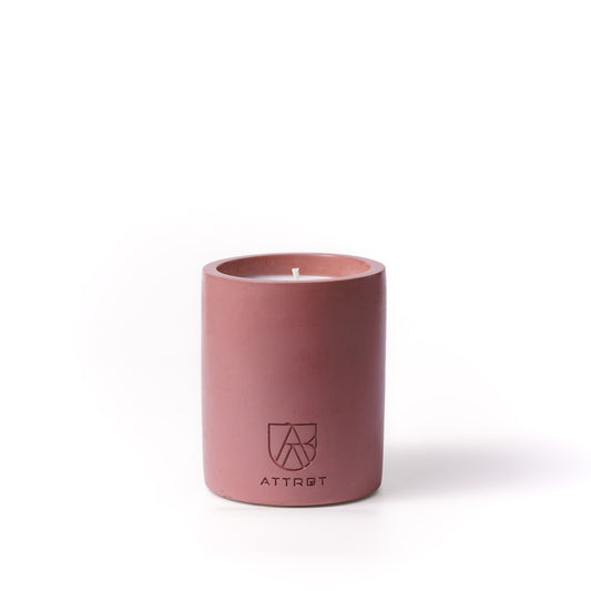 A minimalist one-wick candle in a matte terracotta-colored cylindrical concrete container, featuring the 'ATTRBT' brand logo on the front, set against a clean white background.
noir. concrete candle